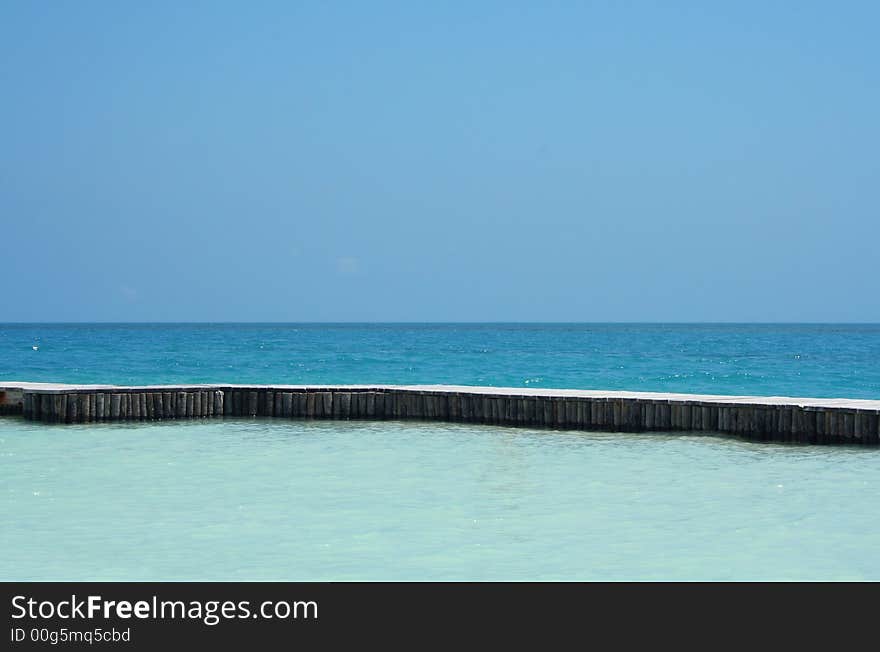 Deep Blue Carribean Ocean broken up by a dock into shades of blue. Deep Blue Carribean Ocean broken up by a dock into shades of blue