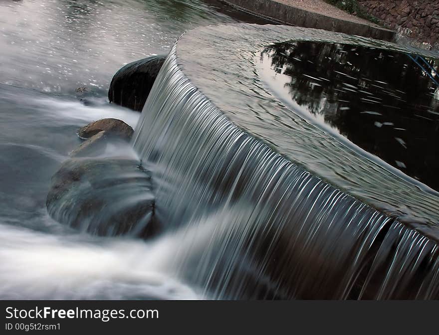 Small waterfall in the park, clean and wispering. Small waterfall in the park, clean and wispering