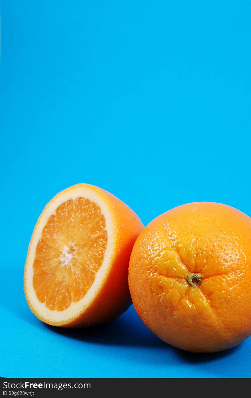 Bright and juicy oranges on a blue background