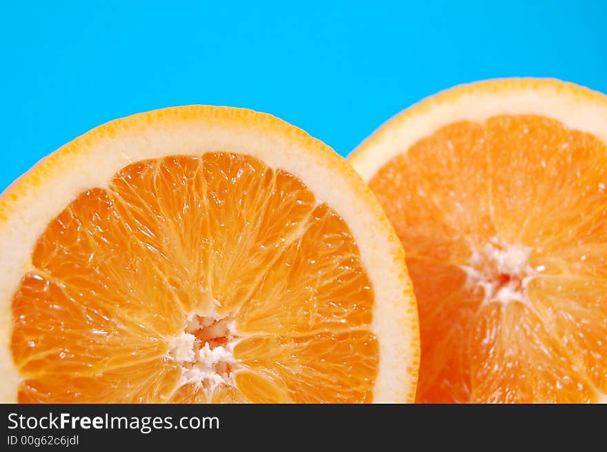 Bright and juicy oranges on a blue background. Bright and juicy oranges on a blue background