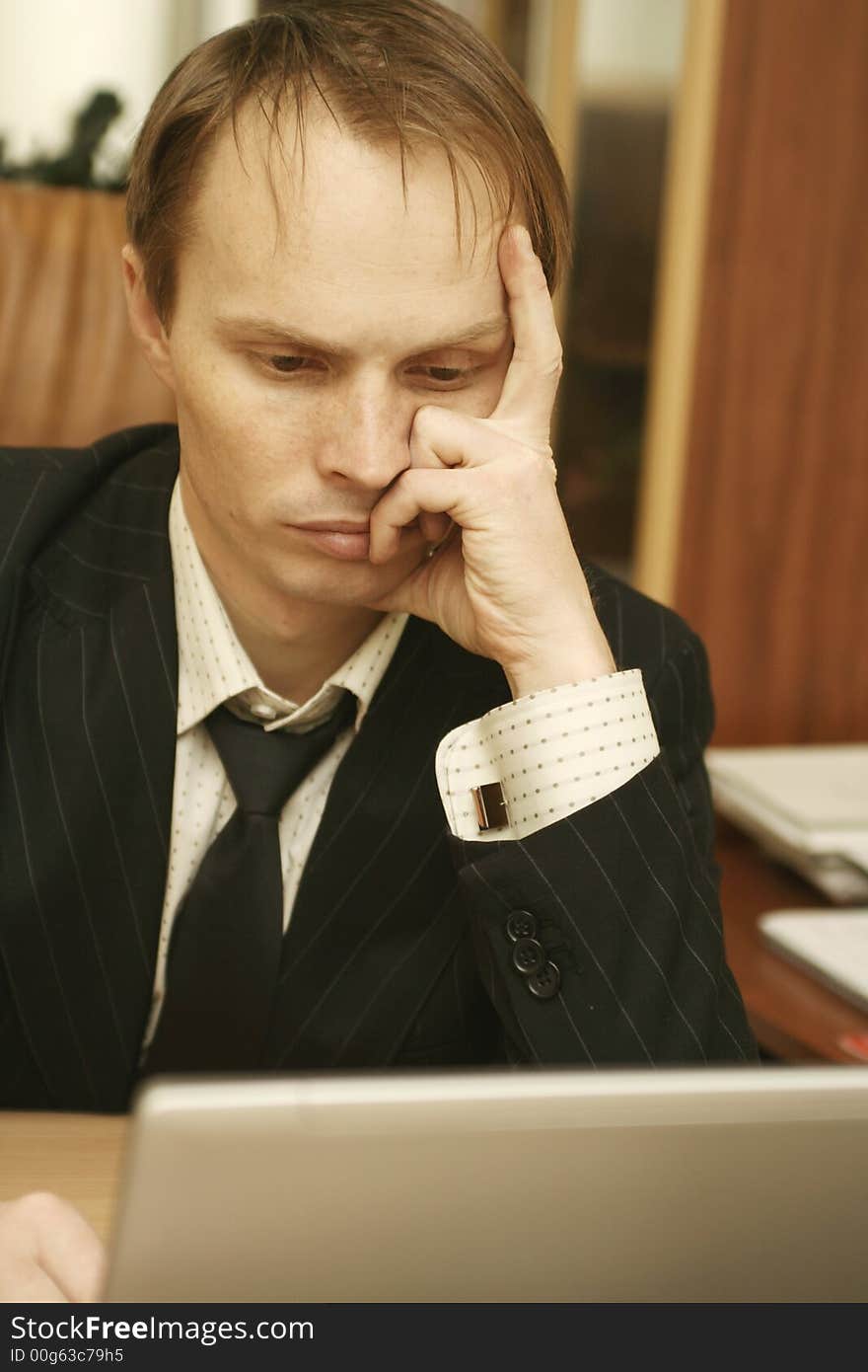 The businessman at office behind a computer