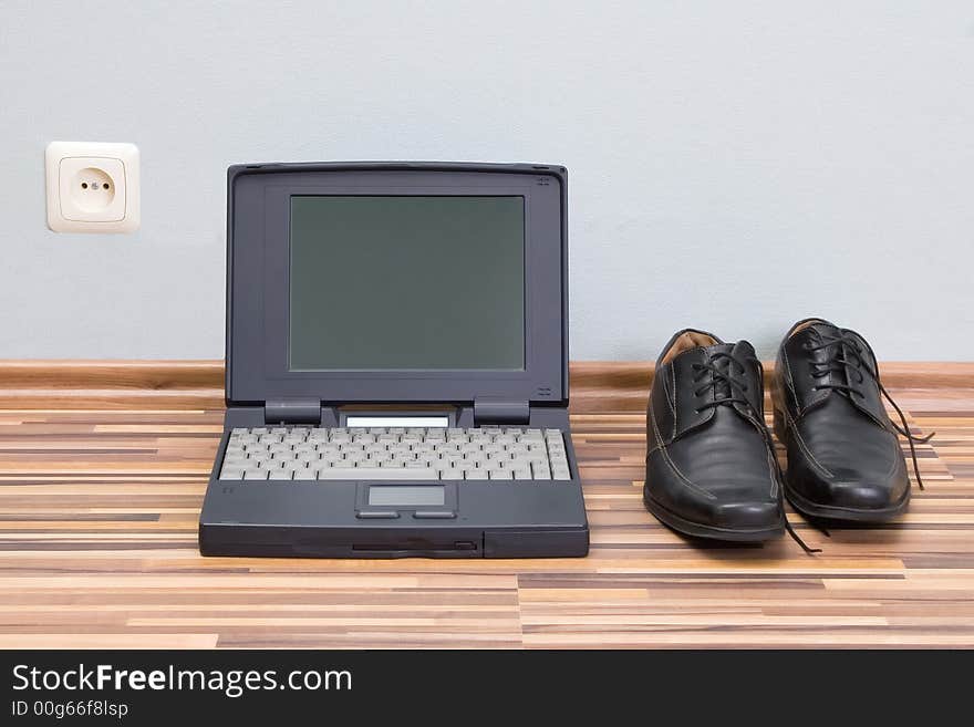 Laptop, shoes, and power outlet