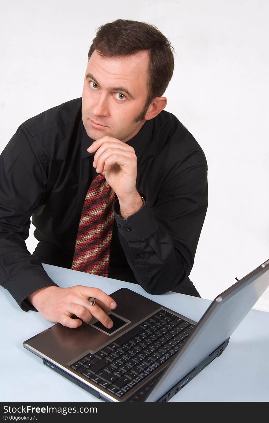 Businessman dressed in suit working on laptop