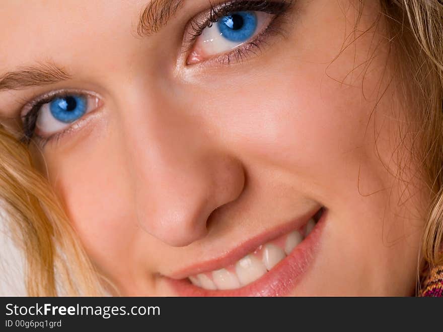 Attractive blue-eyed young woman smiling. Attractive blue-eyed young woman smiling