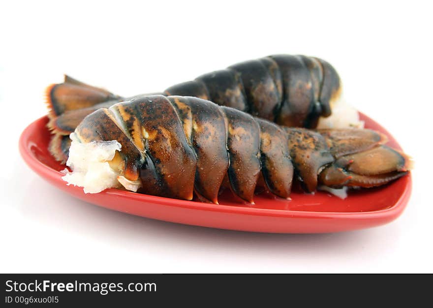 Two lobsters presented on a red plate. Two lobsters presented on a red plate