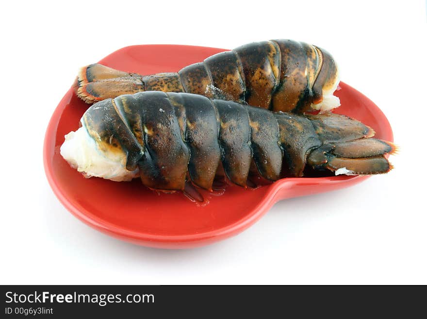 Two lobsters presented on a red plate. Two lobsters presented on a red plate