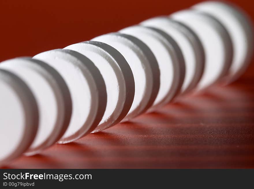 Close-up photo of white pill. Focus on the fourth pill. Shallow DOF. Close-up photo of white pill. Focus on the fourth pill. Shallow DOF