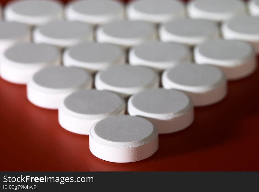 Macro of pills on red background. Shallow DOF. Macro of pills on red background. Shallow DOF