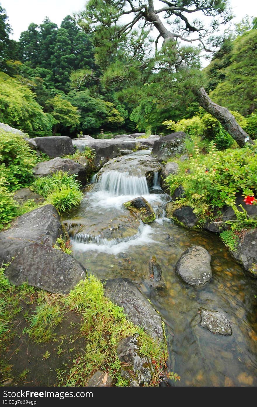 A river cascading down a small water fall. A river cascading down a small water fall