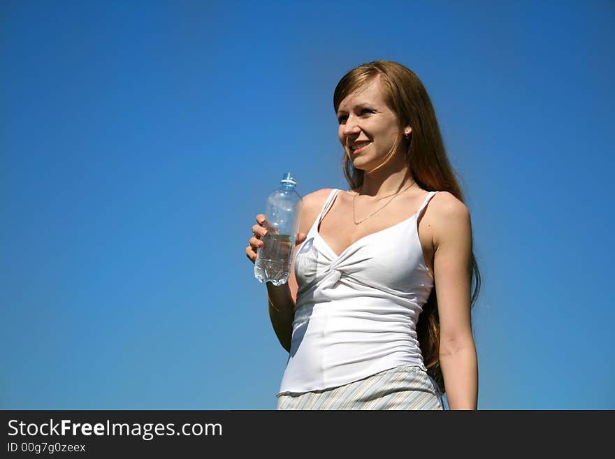 Girl with water on a background of the sky