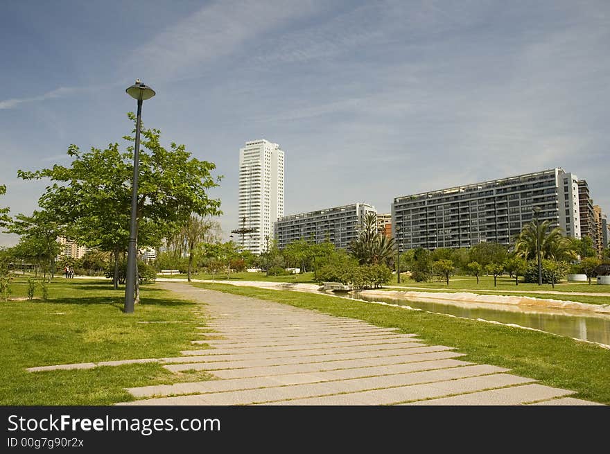 Citypark with skyscraper in the old channel of Turia river in Valencia.