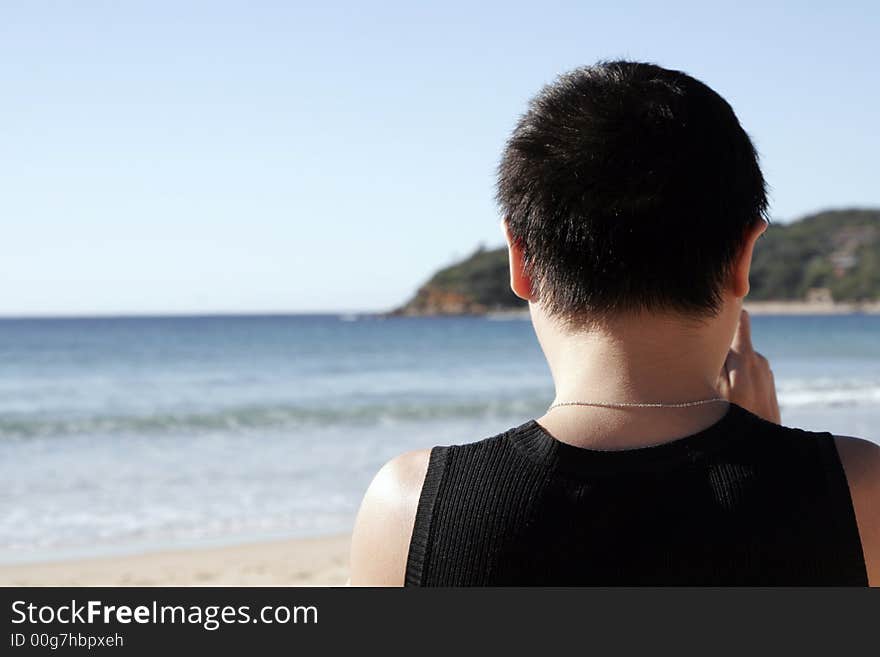 Male Person Standing At The Beach Looking Towards The Ocean, Sydney, Australia. Male Person Standing At The Beach Looking Towards The Ocean, Sydney, Australia