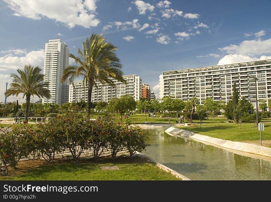 Citypark with skyscraper in the old channel of Turia river in Valencia.