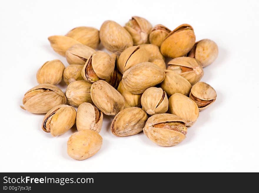 Salty pistachios on the white background. Salty pistachios on the white background