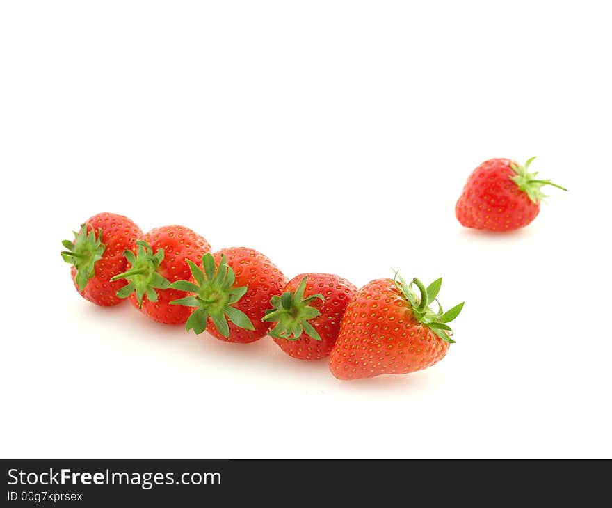 Row of strawberries on white