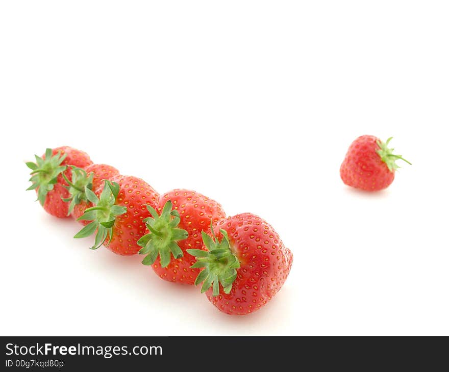 Row of strawberries on white