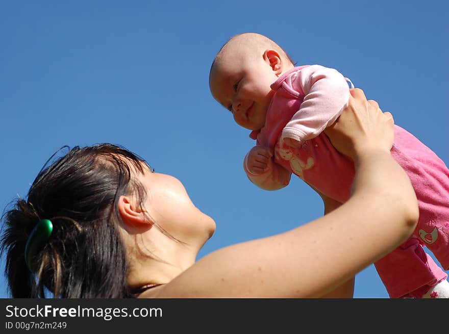 Mother and newborn girl on sky background. Mother and newborn girl on sky background