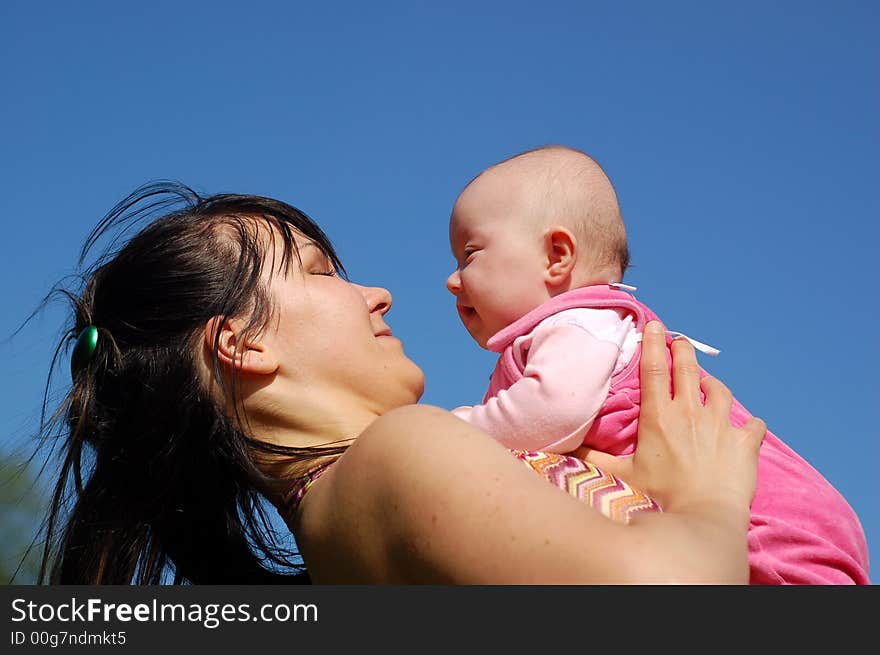 Mother and newborn girl on sky background. Mother and newborn girl on sky background