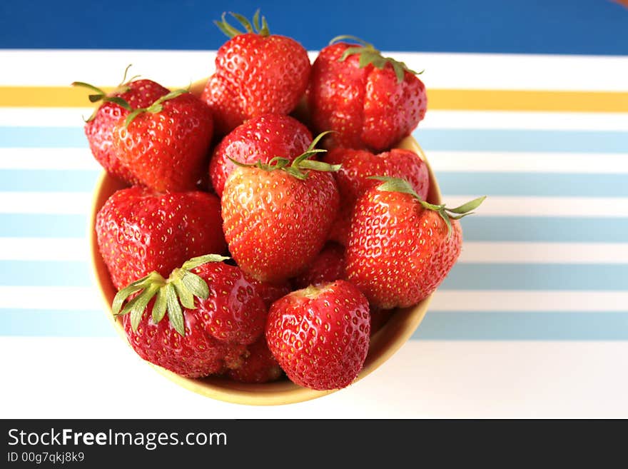 Fresh strawberries with hulls in a row, copy space, isolated on white