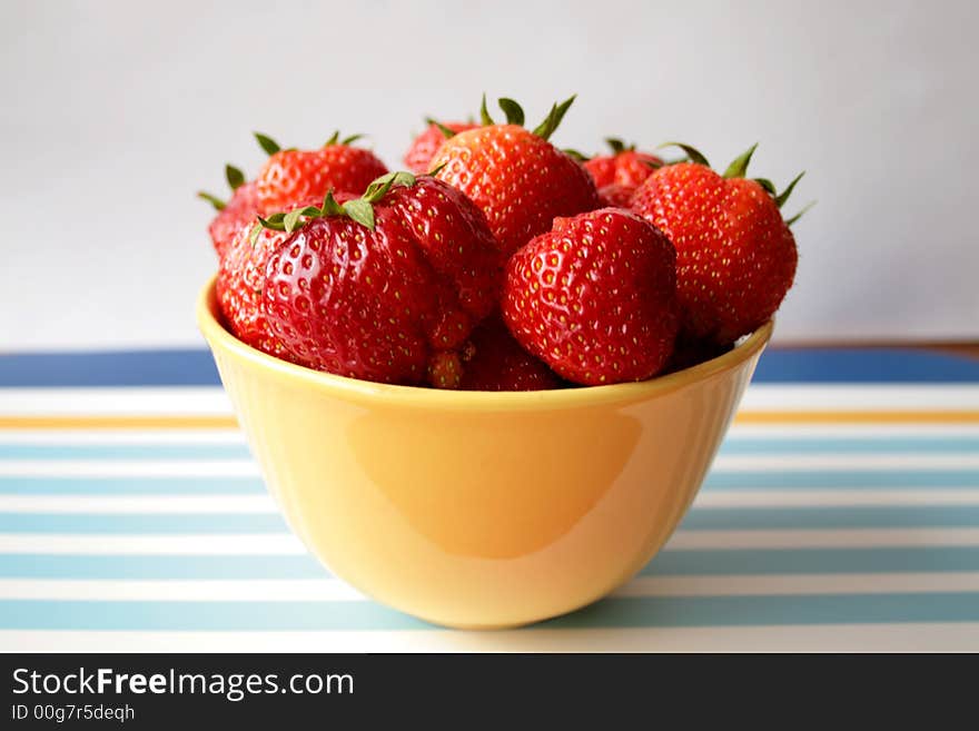 Fresh strawberries with hulls in a row, copy space, isolated on white