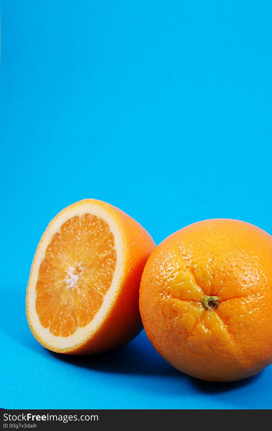 Bright juicy oranges on a blue background. Bright juicy oranges on a blue background