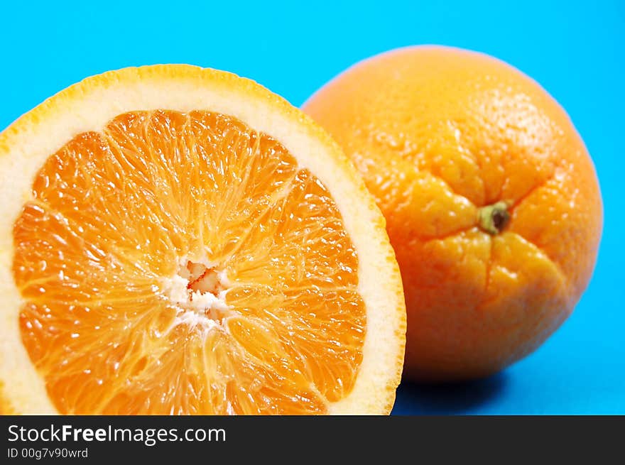 Bright juicy oranges on a blue background. Bright juicy oranges on a blue background