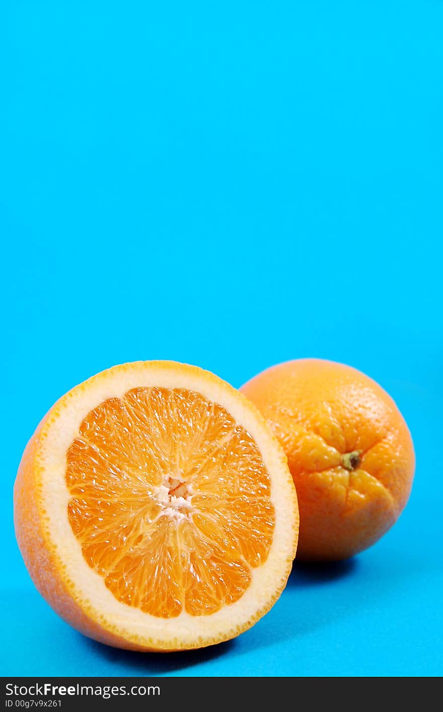 Bright juicy oranges on a blue background. Bright juicy oranges on a blue background