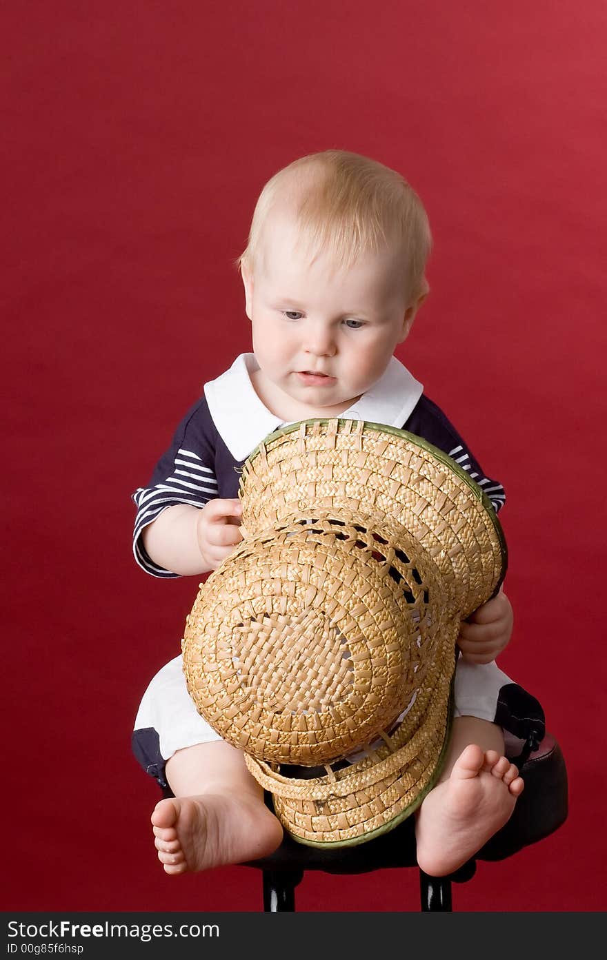 The small smiling child in studio, on a red background. The small smiling child in studio, on a red background