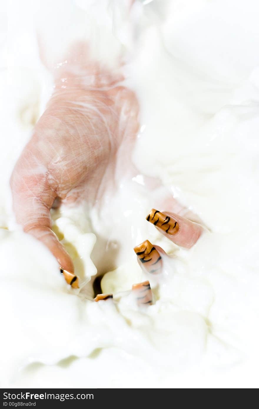 Women hand with manicure in the milk. Women hand with manicure in the milk