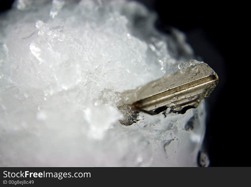 House Key frozen in a blockof ice. House Key frozen in a blockof ice