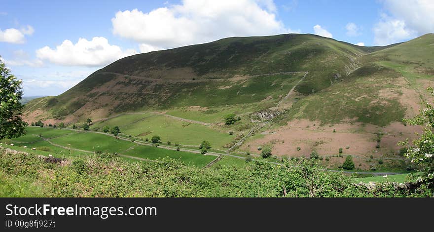 Landscape image of rolling hills under a cloudy sky. Landscape image of rolling hills under a cloudy sky