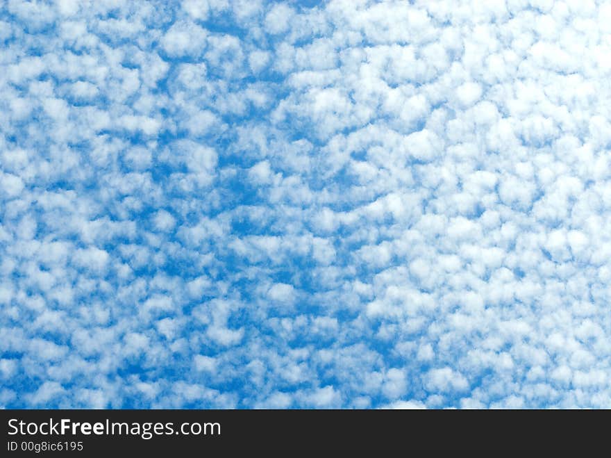 Congestion of small white clouds in the blue sky