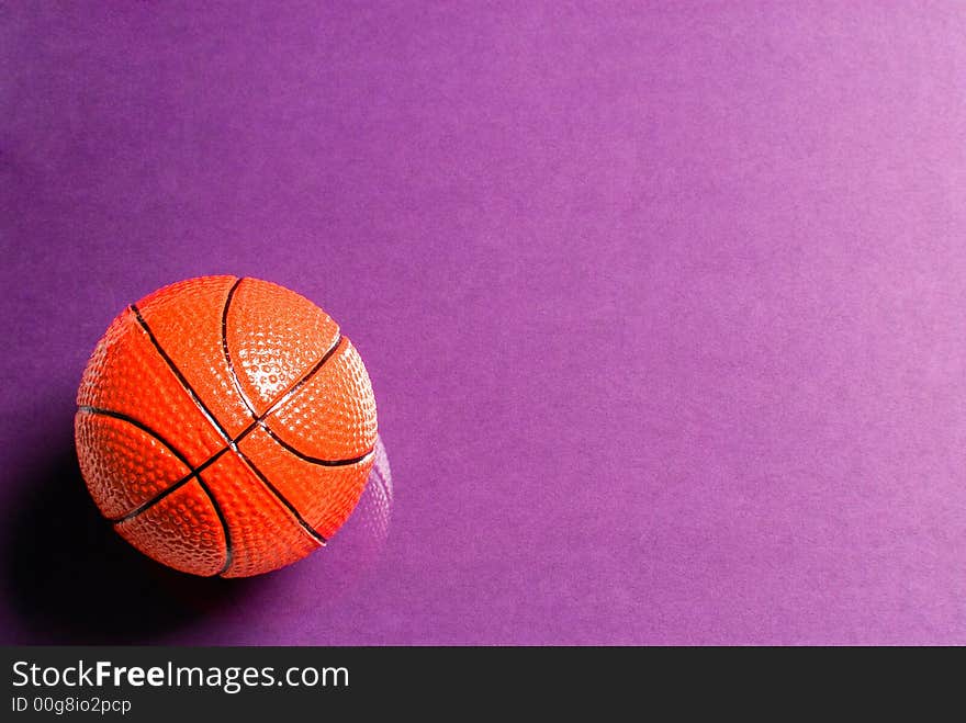 Basketball ball on glass with a violet background