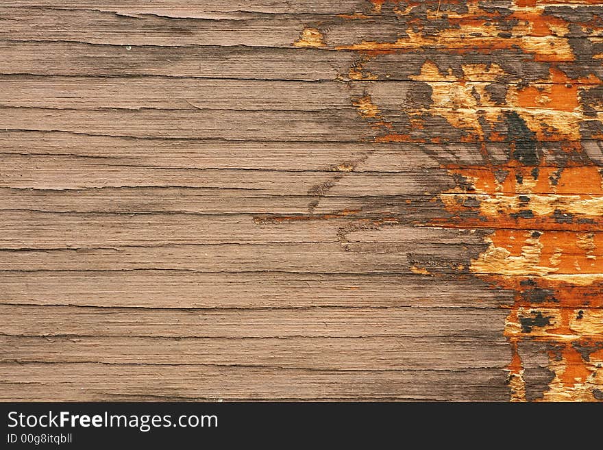 Brown grungy wooden board with vivid orange scratches on the right side. Brown grungy wooden board with vivid orange scratches on the right side