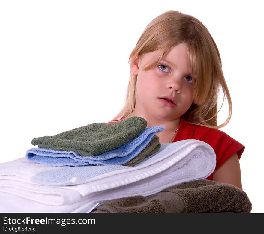 Unhappy, disgusted young girl helping with laundry carrying towels