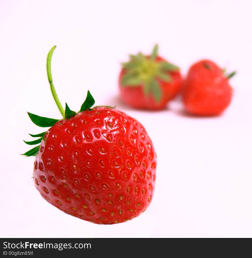 The strawberries on a white background.