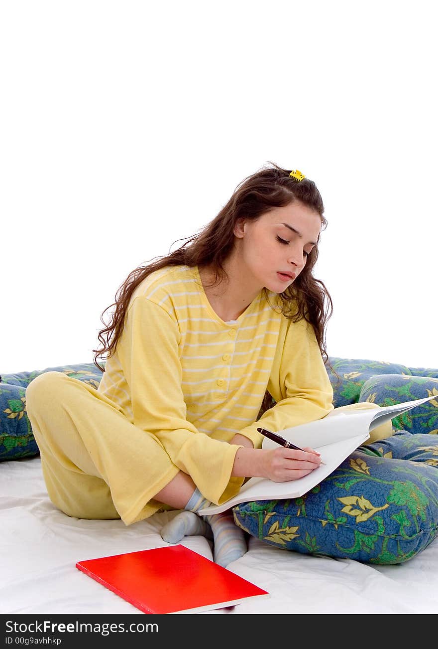 Beautiful young woman in pajamas study in bed. Beautiful young woman in pajamas study in bed