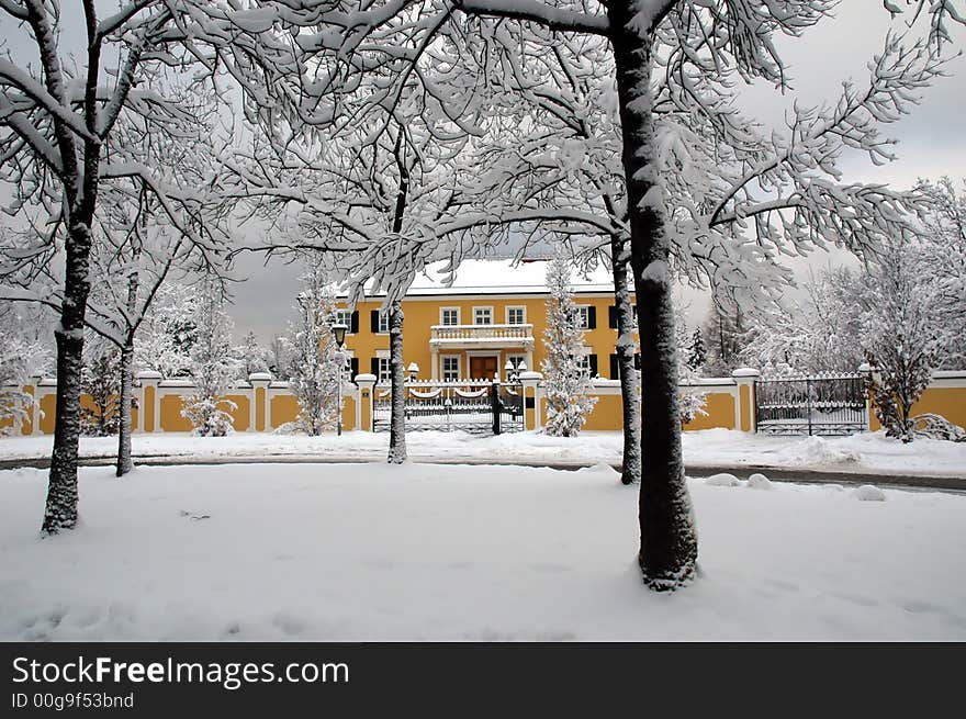 A yellow mansion peaking out fromt he darkness of winter. A yellow mansion peaking out fromt he darkness of winter