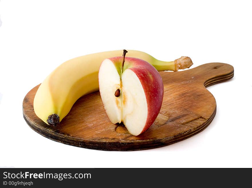 Apple and banana on chopping board isolated on white with shadow