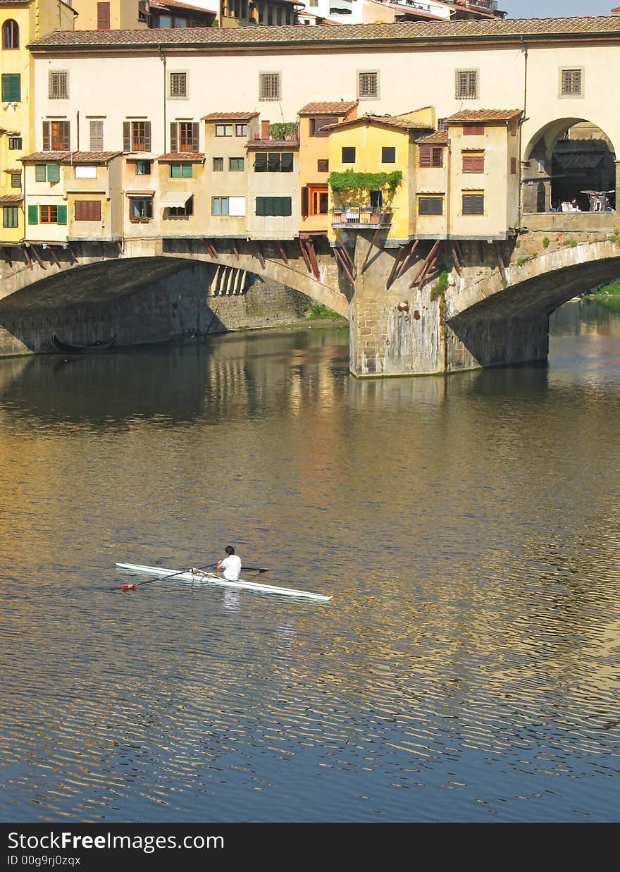 Sculling in the Arno near Ponte Vecchio, Florence, Italy. Sculling in the Arno near Ponte Vecchio, Florence, Italy