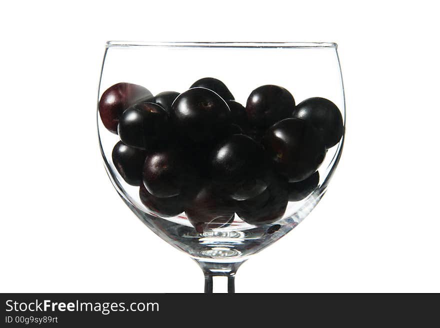 Cup with little dark fruits. Cup with little dark fruits