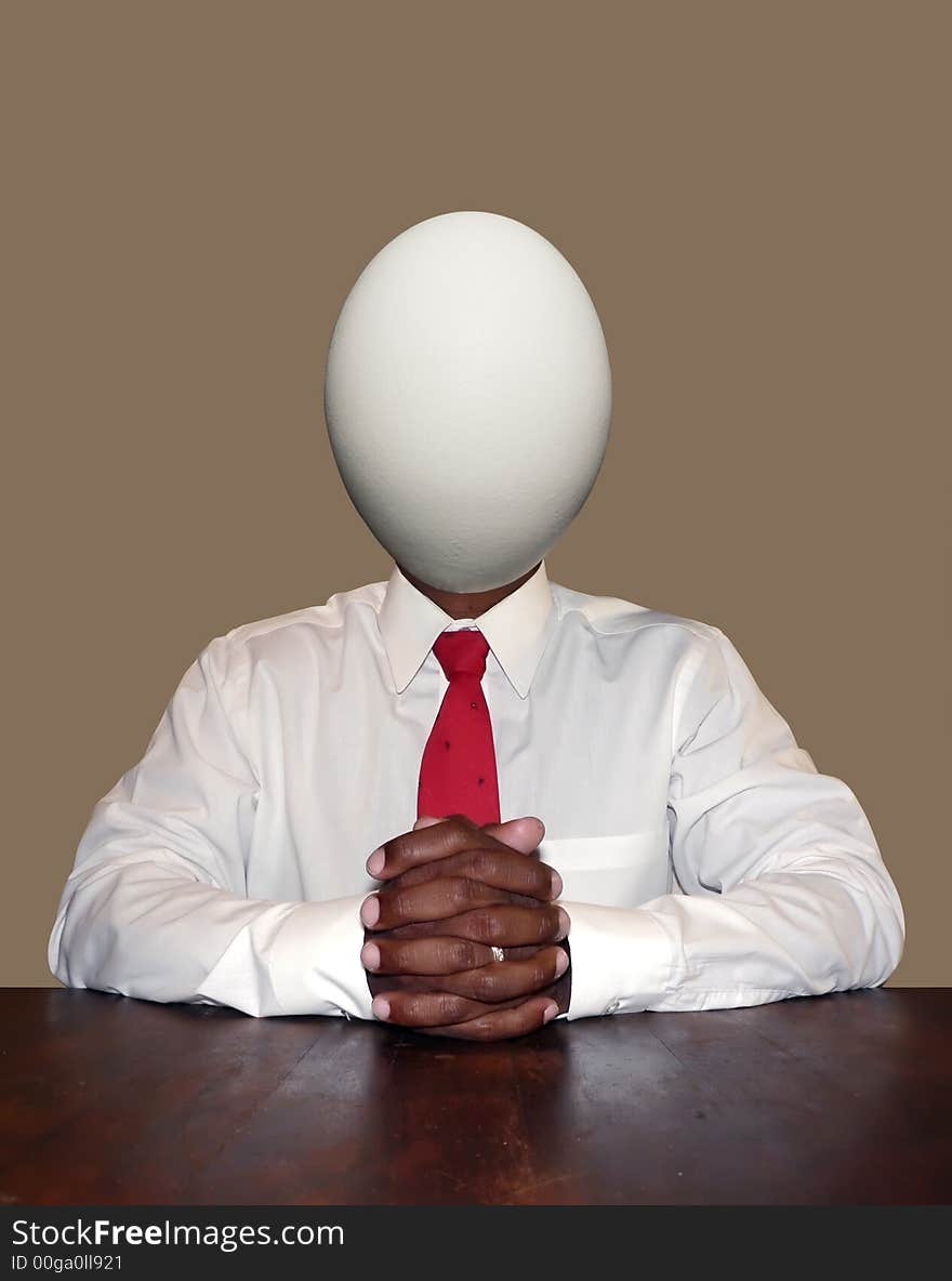 Unintelligent and dumb businessman personality concept photo manipulation depicting a egg for a head sitting at a desk ready for a meeting. isolated over a neutral colored background. clipping path included. Unintelligent and dumb businessman personality concept photo manipulation depicting a egg for a head sitting at a desk ready for a meeting. isolated over a neutral colored background. clipping path included