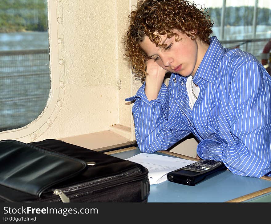 Teenager doing math homework on a ferry boat. Teenager doing math homework on a ferry boat