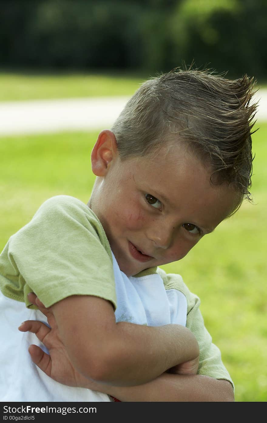 Young boy with cool hair grinning