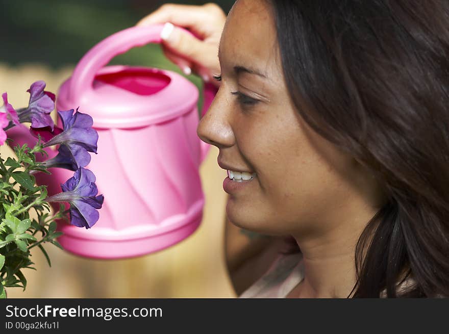 Young lady in garden with flowers. Young lady in garden with flowers