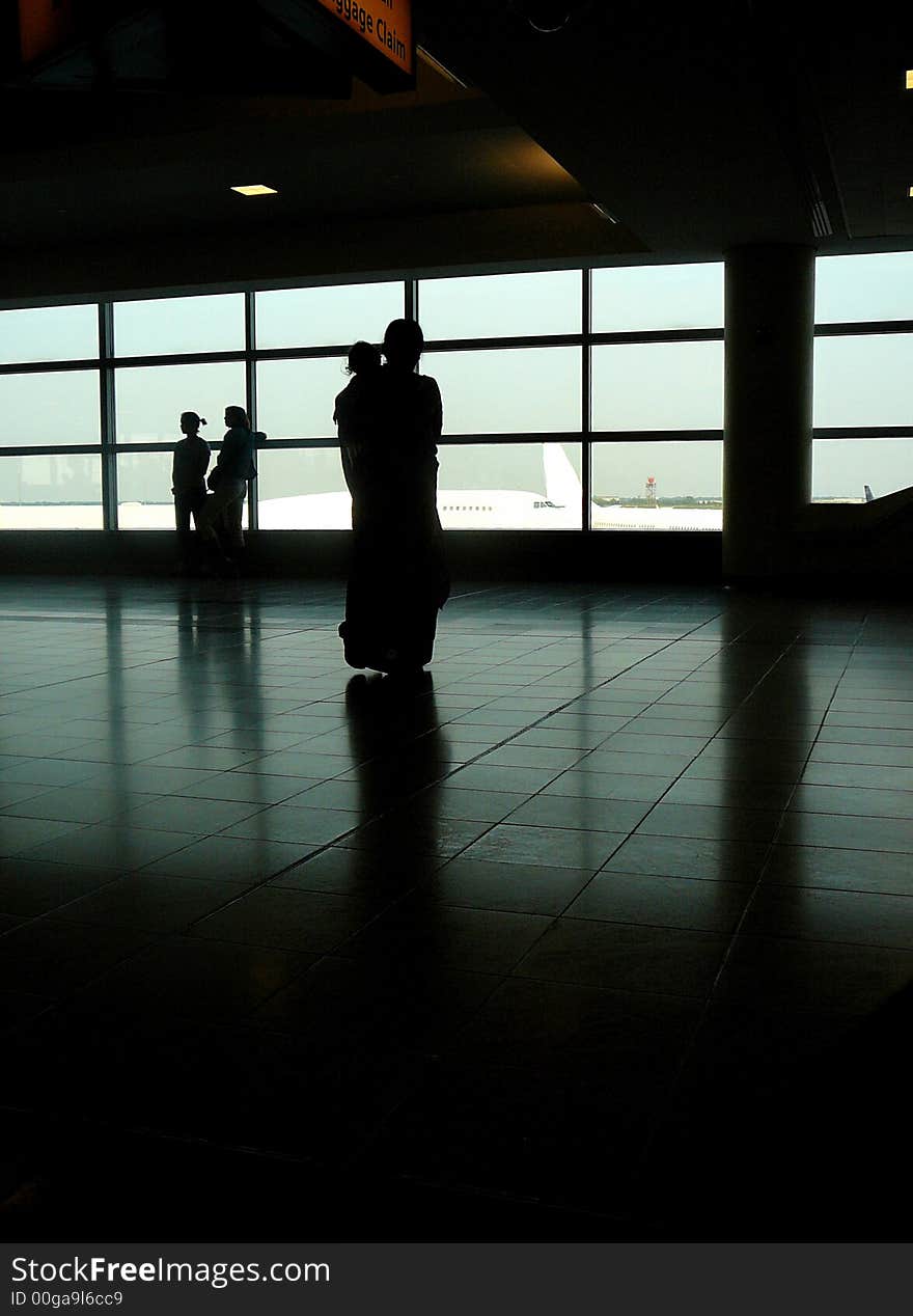 Mother and Child Watching Airplanes From Departure Area of Airport