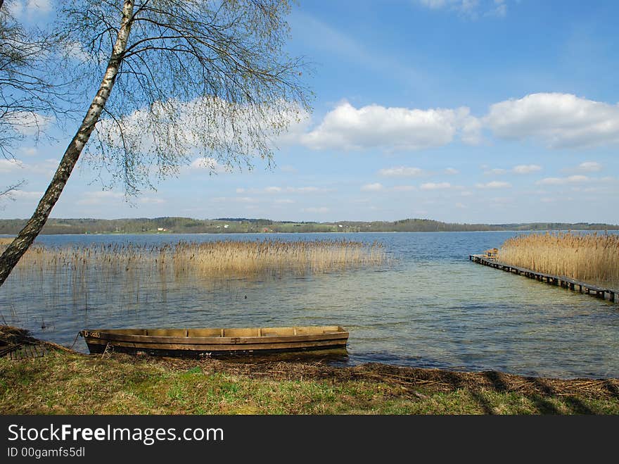 Coast of lake with a boat in the foreground. Coast of lake with a boat in the foreground