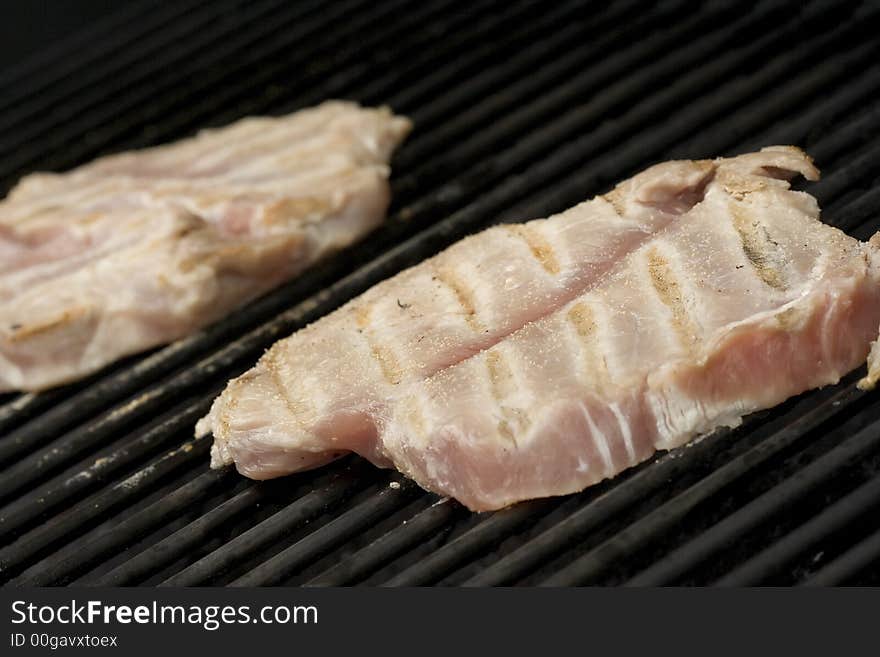 Pork chops on the grill.  Grill marks and close up detail. Pork chops on the grill.  Grill marks and close up detail