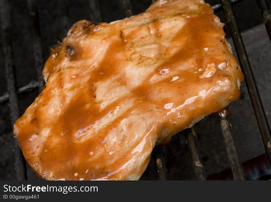 Pork chops on the grill. Grill marks and close up detail. Pork chops on the grill. Grill marks and close up detail