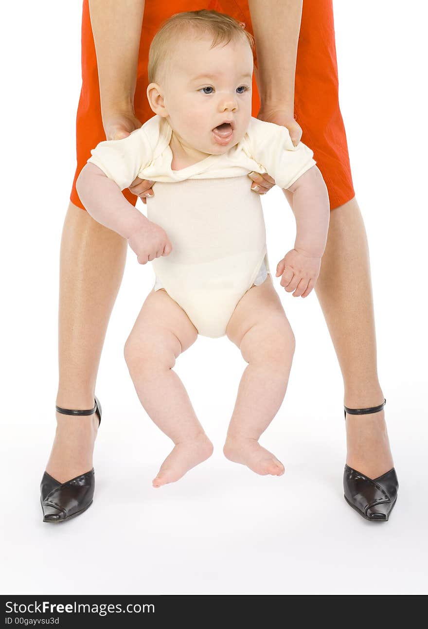 Young mother holding her sleepy baby boy. White background, front view. Young mother holding her sleepy baby boy. White background, front view